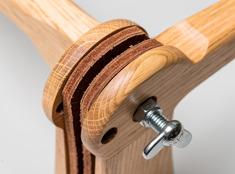 Detail shot of stitching pony jaw mechanism with leather padding strips installed and oak construction visible
