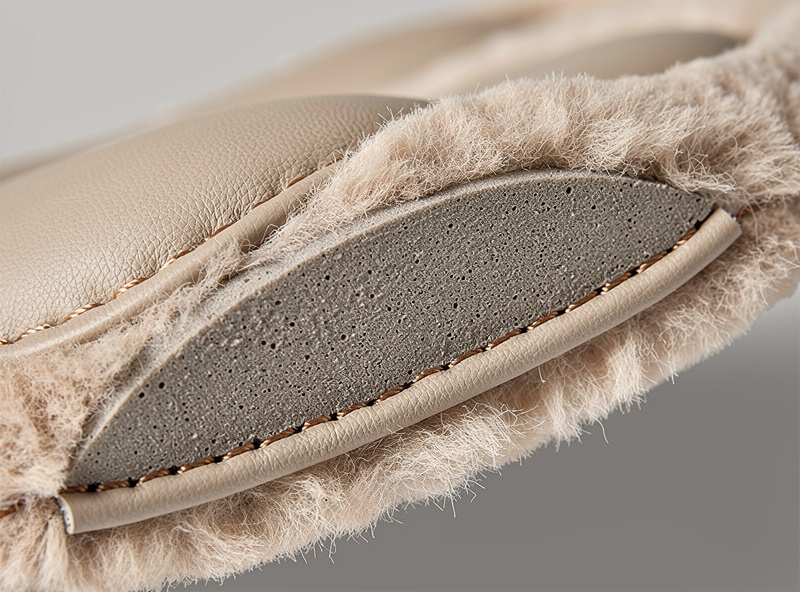 Macro close-up of leather earpad cross-section showing memory foam core and sheepskin covering