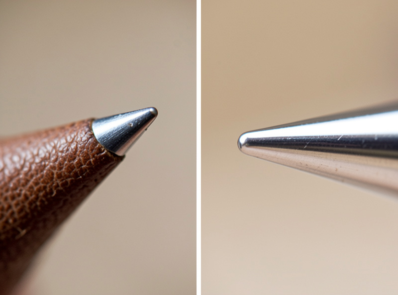 Close-up of leather sewing machine needles showing the blade-shaped cutting point compared to a round-point needle