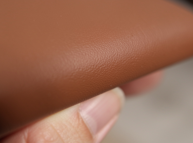 A smooth fully sanded leather edge ready for burnishing held up to workshop light