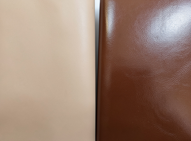 A natural matte aniline leather swatch compared side by side with a glossy pigmented protected leather swatch