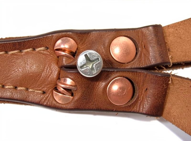 Chicago screw and copper rivets set through a doubled leather strap end