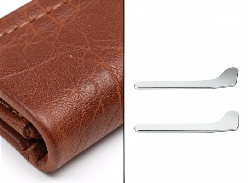 Comparison of a bulky thick folded leather tab beside a clean thin skived tab on zipper ends