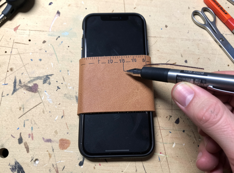 Wrapping veg-tan leather around a smartphone to measure girth for a sleeve pattern