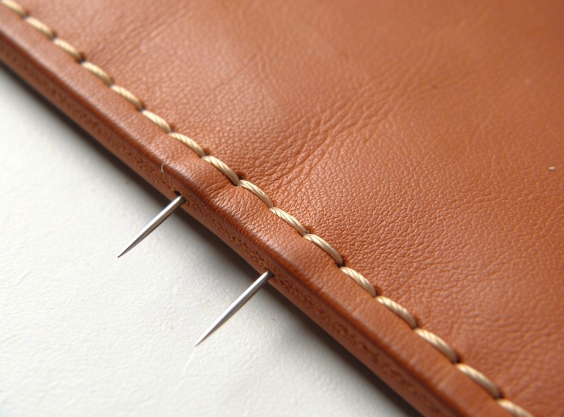 Saddle stitching the long side seam of a leather phone sleeve with two needles