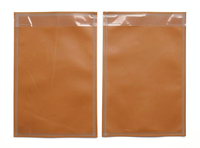 Two cut veg-tan leather panels with zipper tape glued along the top edges before stitching