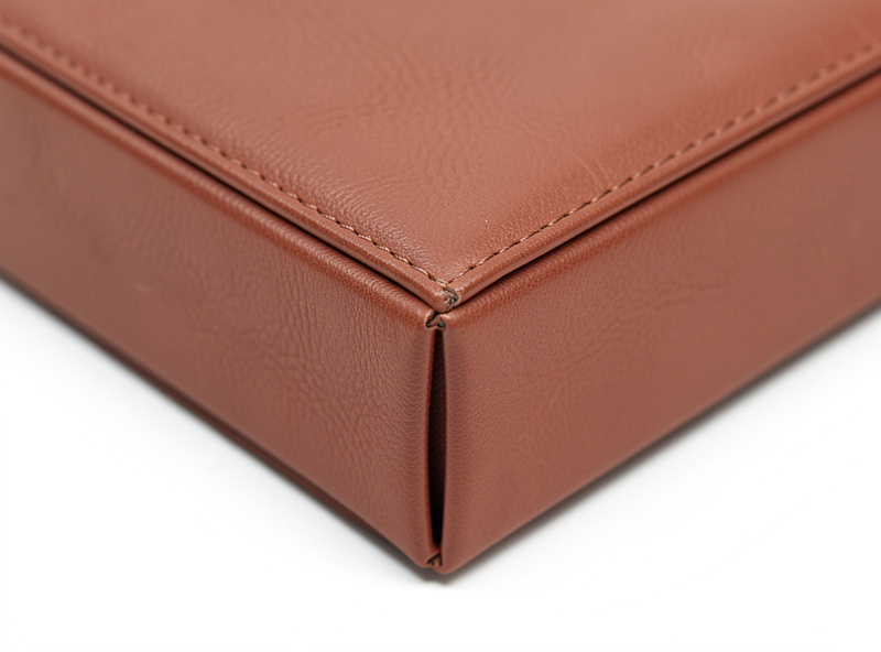 Close-up of a boxed corner on a finished leather zipper pouch turned right side out